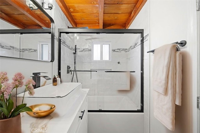 full bathroom featuring wooden ceiling, bath / shower combo with glass door, beamed ceiling, and vanity