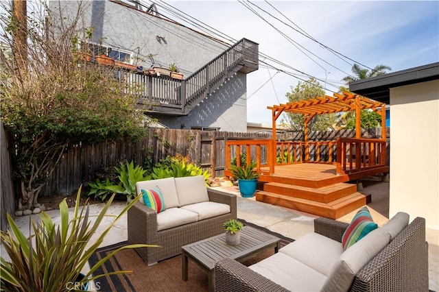 view of patio / terrace with a fenced backyard, outdoor lounge area, and a wooden deck