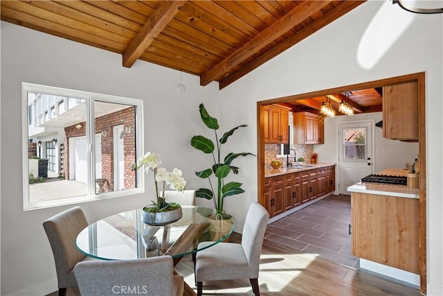 dining space with wooden ceiling, dark wood finished floors, and lofted ceiling with beams