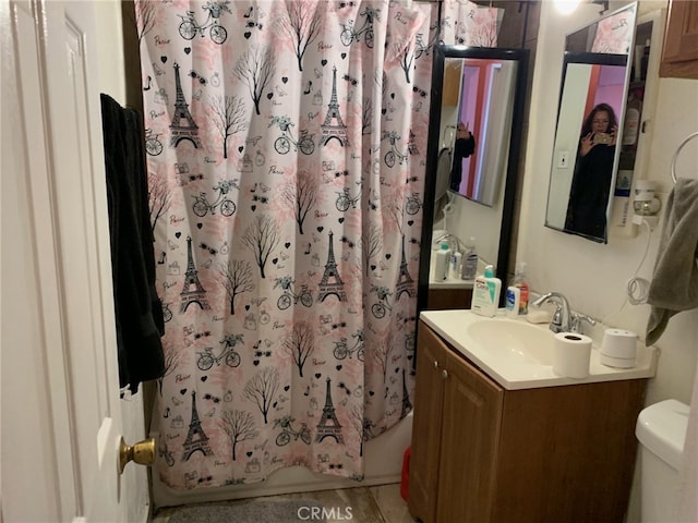 bathroom featuring shower / tub combo with curtain, vanity, and toilet