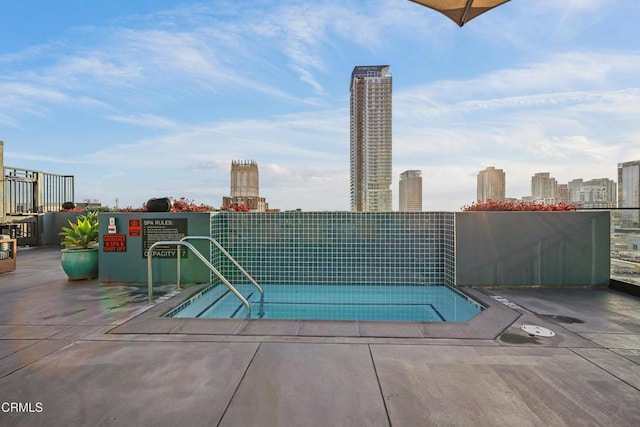 view of pool with a city view