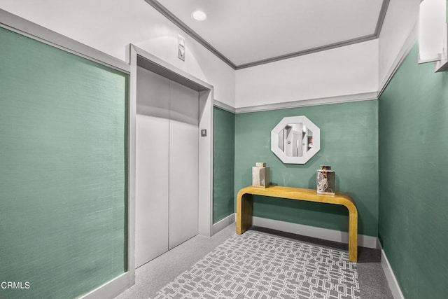 bathroom featuring ornamental molding, elevator, and baseboards