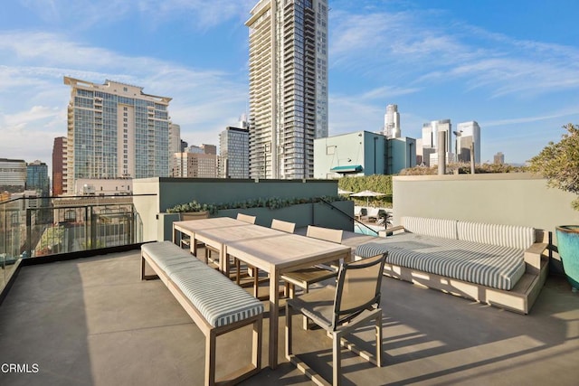 view of patio featuring a view of city and outdoor dining area