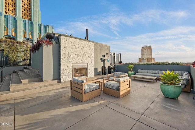 view of patio featuring an outdoor living space with a fireplace