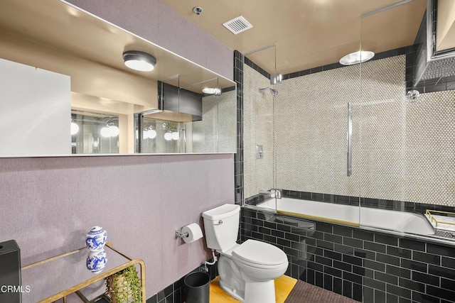 full bathroom with visible vents, toilet, and tiled shower / bath combo