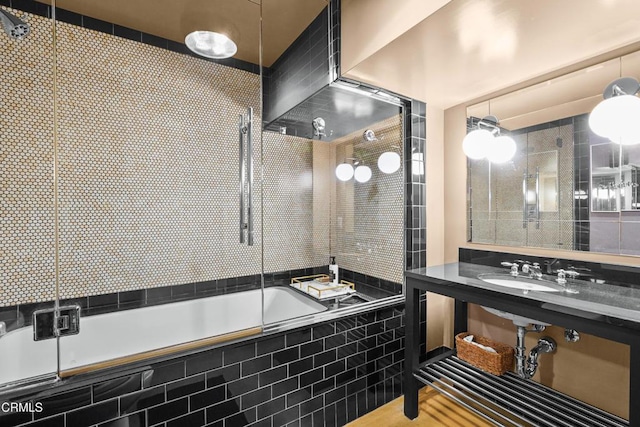 bathroom featuring tiled shower / bath and a sink