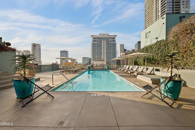 pool featuring a view of city and a patio area