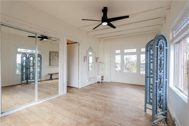 unfurnished sunroom featuring ceiling fan