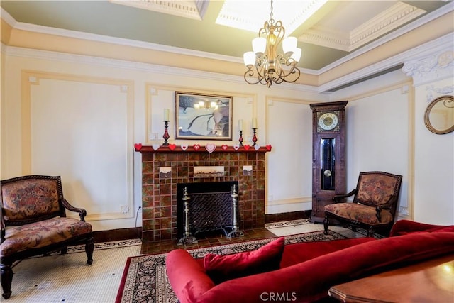 living area with a fireplace, ornamental molding, a chandelier, and wood finished floors