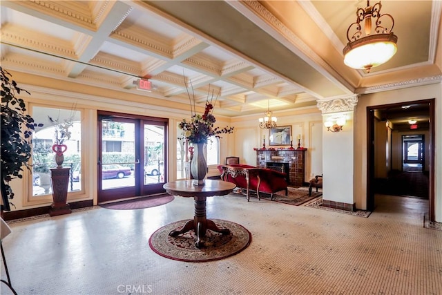 entrance foyer with coffered ceiling, ornamental molding, french doors, a fireplace, and beam ceiling