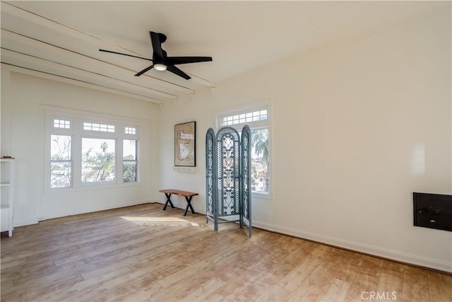 foyer entrance with light wood-style floors, baseboards, and a ceiling fan