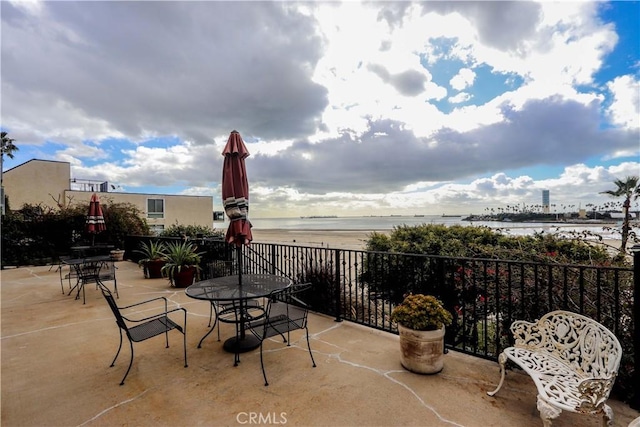 view of patio / terrace featuring outdoor dining area and a water view