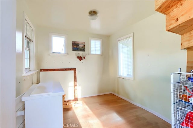 interior space with baseboards and wood finished floors