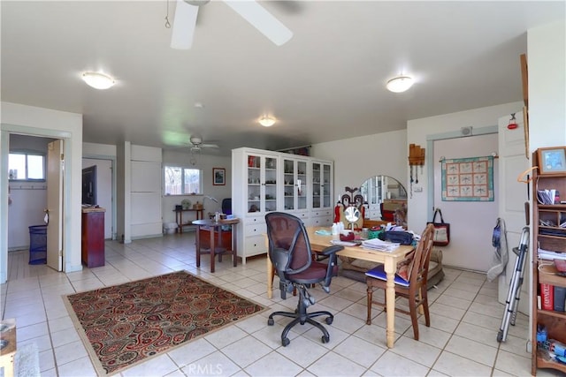 office space with a ceiling fan and light tile patterned floors