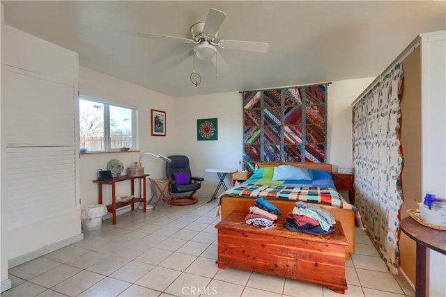 bedroom with a ceiling fan and light tile patterned floors