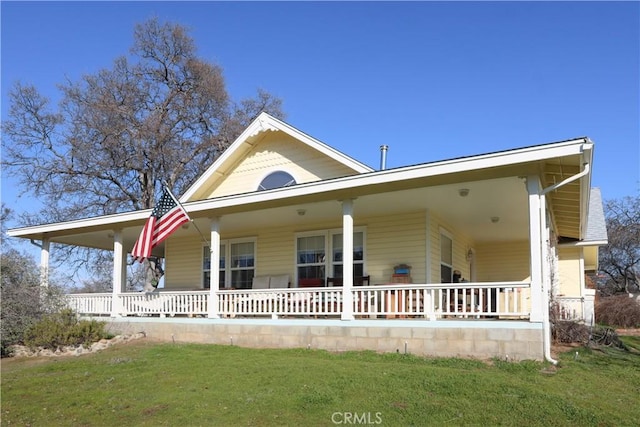 farmhouse inspired home with a porch and a front lawn