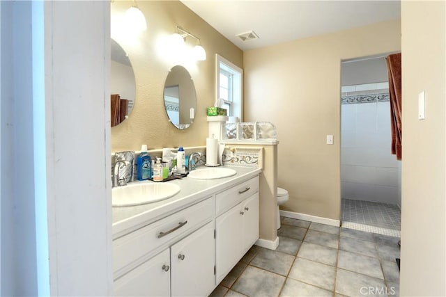 full bathroom with toilet, double vanity, visible vents, and a sink