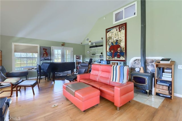 living room featuring visible vents, high vaulted ceiling, wood finished floors, and french doors