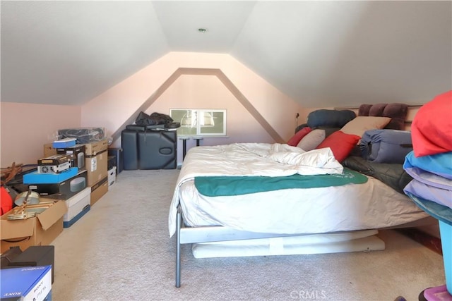 bedroom with carpet floors and lofted ceiling