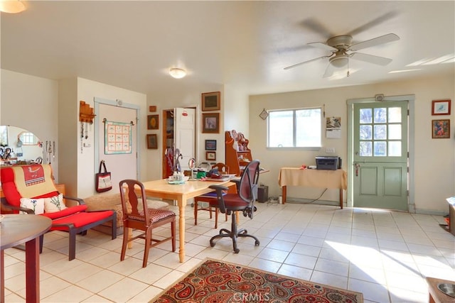 dining space featuring light tile patterned floors and a ceiling fan