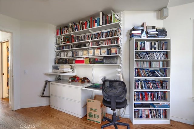 office with baseboards and wood finished floors