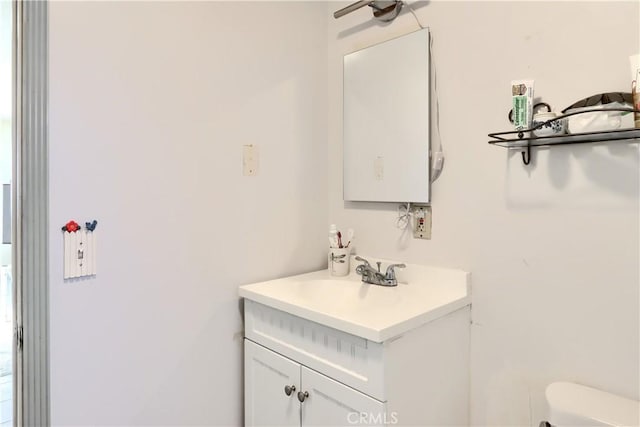 half bath featuring toilet and vanity