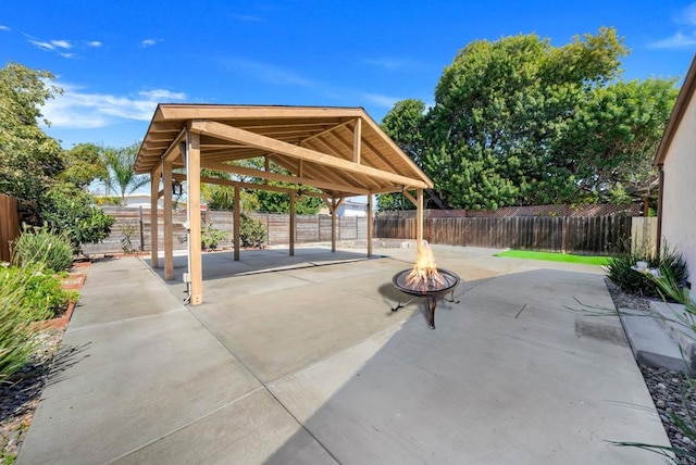 view of patio with a gazebo, a fire pit, and a fenced backyard