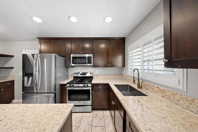 kitchen with marble finish floor, a sink, recessed lighting, dark brown cabinetry, and appliances with stainless steel finishes