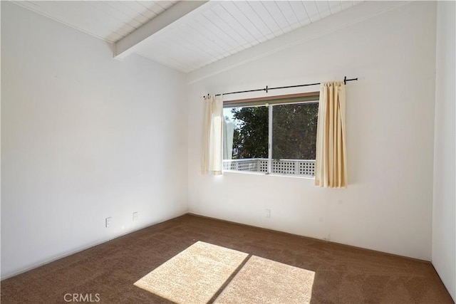 carpeted empty room with vaulted ceiling with beams