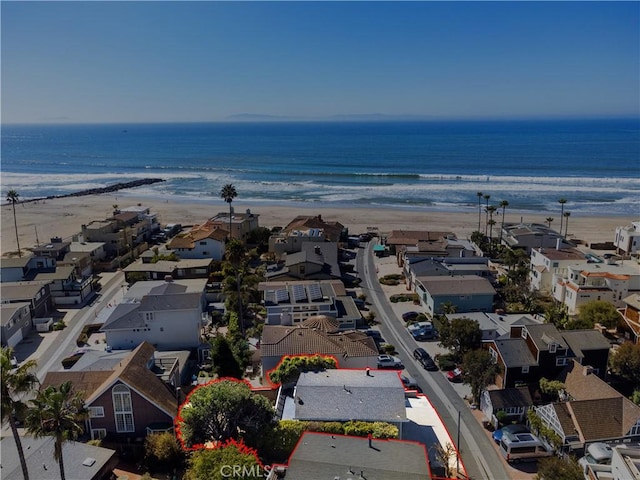 drone / aerial view with a residential view, a view of the beach, and a water view