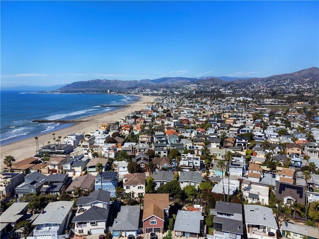 bird's eye view featuring a residential view, a water and mountain view, and a view of the beach