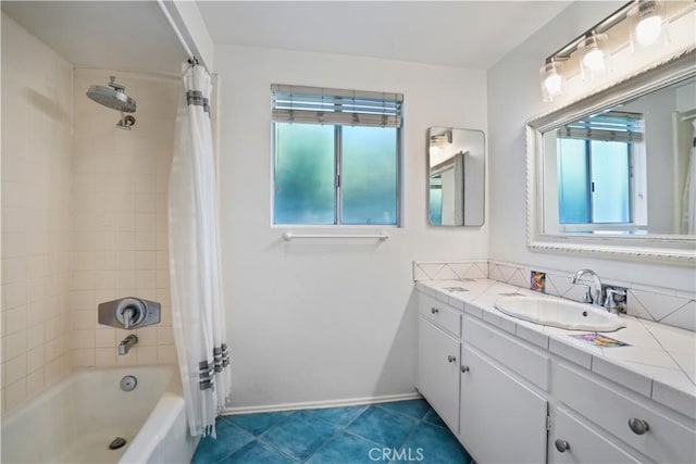 full bathroom featuring baseboards, shower / bath combo with shower curtain, vanity, and tile patterned flooring