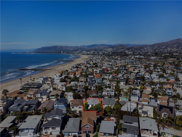 bird's eye view featuring a residential view, a water and mountain view, and a view of the beach