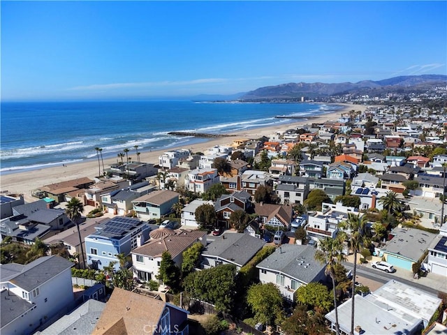 drone / aerial view featuring a residential view, a view of the beach, and a water view