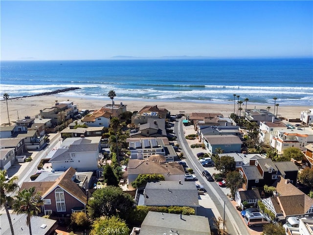 bird's eye view featuring a water view and a beach view