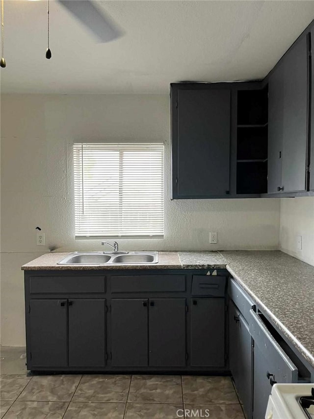 kitchen featuring light tile patterned floors, open shelves, and a sink