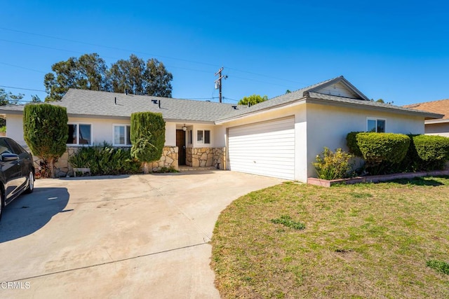 ranch-style house featuring stucco siding, a garage, stone siding, driveway, and a front lawn