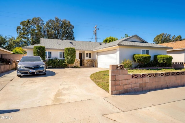 single story home with an attached garage, a shingled roof, fence, concrete driveway, and stucco siding