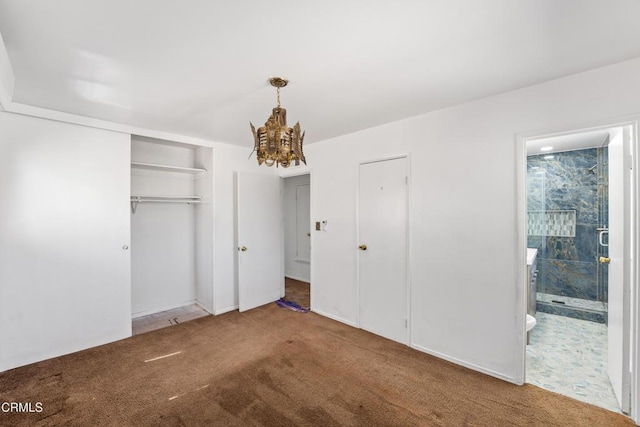 unfurnished bedroom with carpet, a notable chandelier, and ensuite bathroom