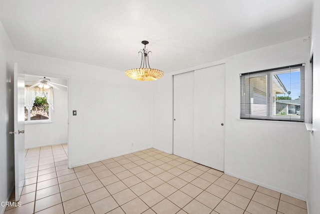 unfurnished room featuring ceiling fan and light tile patterned floors