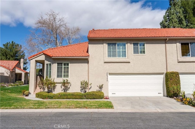 view of front of house featuring concrete driveway, an attached garage, a tile roof, and stucco siding