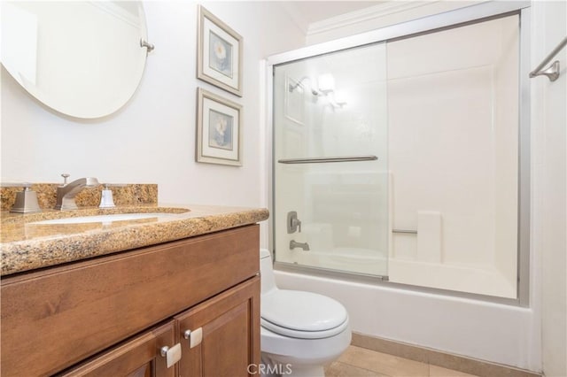 bathroom with tile patterned flooring, toilet, shower / bath combination with glass door, vanity, and crown molding