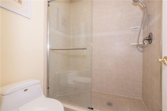 full bath featuring a tile shower and toilet