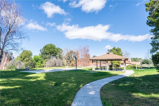 view of property's community with a lawn and a gazebo