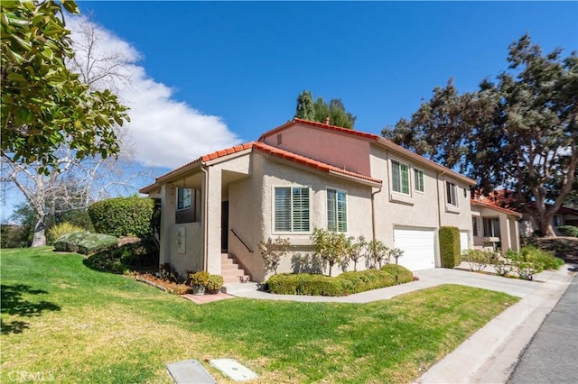 mediterranean / spanish-style home featuring an attached garage, a tiled roof, driveway, stucco siding, and a front lawn