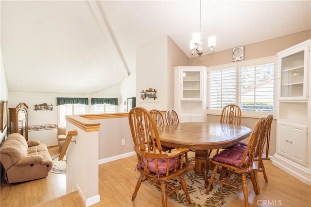 dining space with light wood-type flooring, baseboards, vaulted ceiling, and a notable chandelier