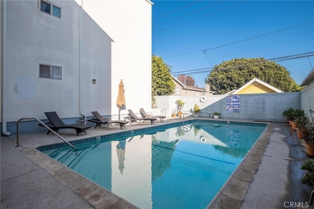 view of swimming pool with a fenced in pool, a patio area, and a fenced backyard