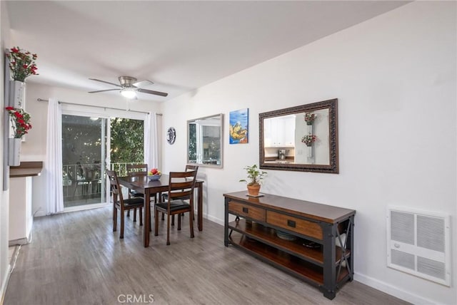 dining space with visible vents, wood finished floors, a ceiling fan, and baseboards