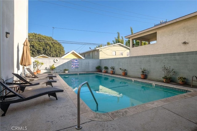 view of pool featuring a fenced backyard, a fenced in pool, and a patio