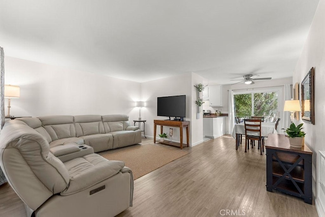 334 Gladys Ave Unit 103, Long Beach, CA 90814 - living room featuring a ceiling fan, light wood-style floors, and baseboards